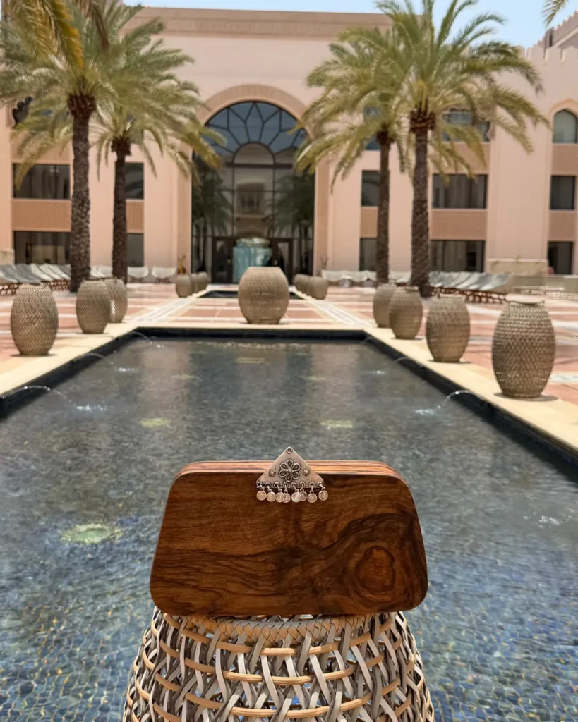 Kord Hand Bag in hotel near pool palm
